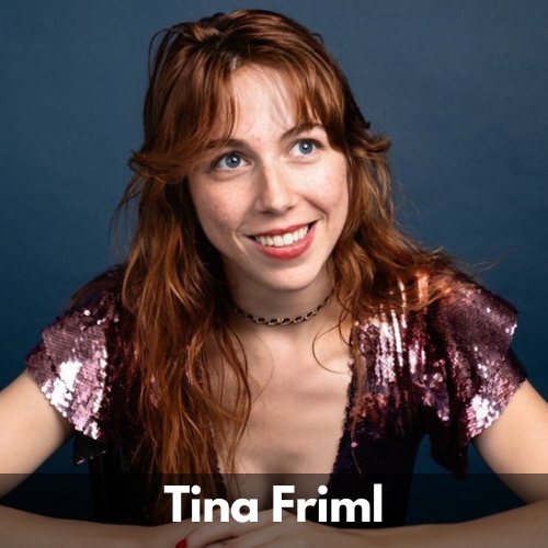 Tina Friml is a white woman in her 30s. She has wavy reddish-brown hair past her shoulders, blue eyes and a bright smile. She wears a purple sparkly shirt.